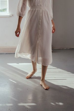 White dress in afternoon sunlight on a concrete floor